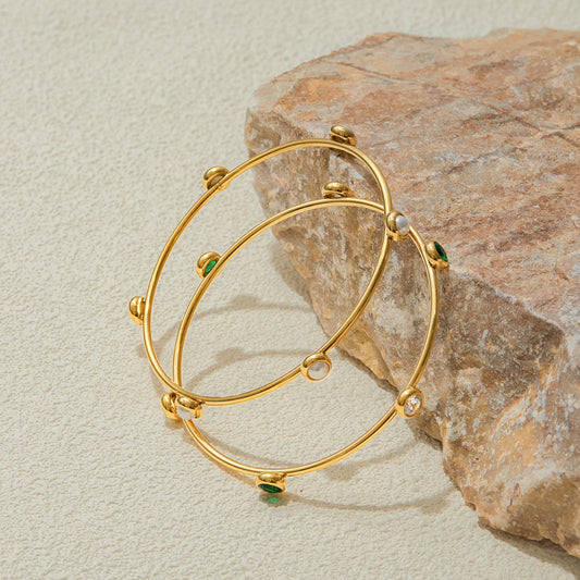 Gold bracelet with green stones