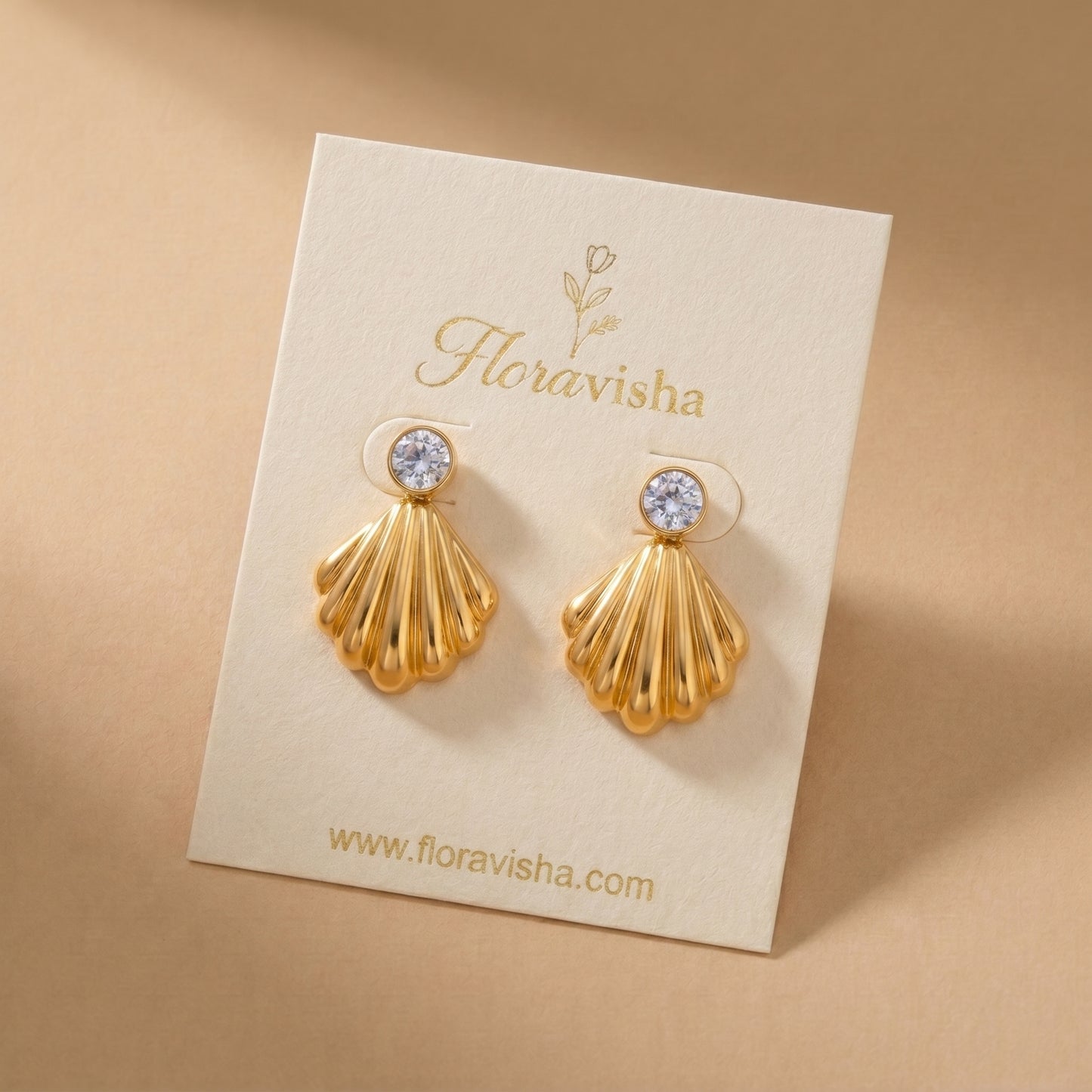 Waterproof gold-plated scallop shell drop earrings featuring a brilliant crystal stud by Floravisha. Displayed on a clean background highlighting the high-quality, skin-friendly jewelry design.