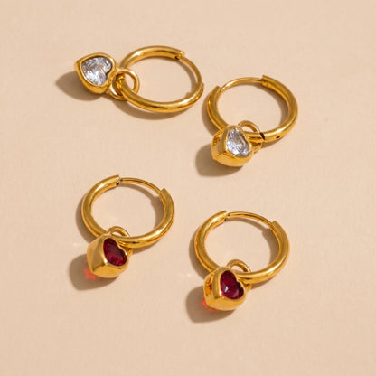 High quality waterproof gold plated huggie hoop earrings featuring sparkling ruby red and clear crystal heart dangle charms, displayed on a clean background