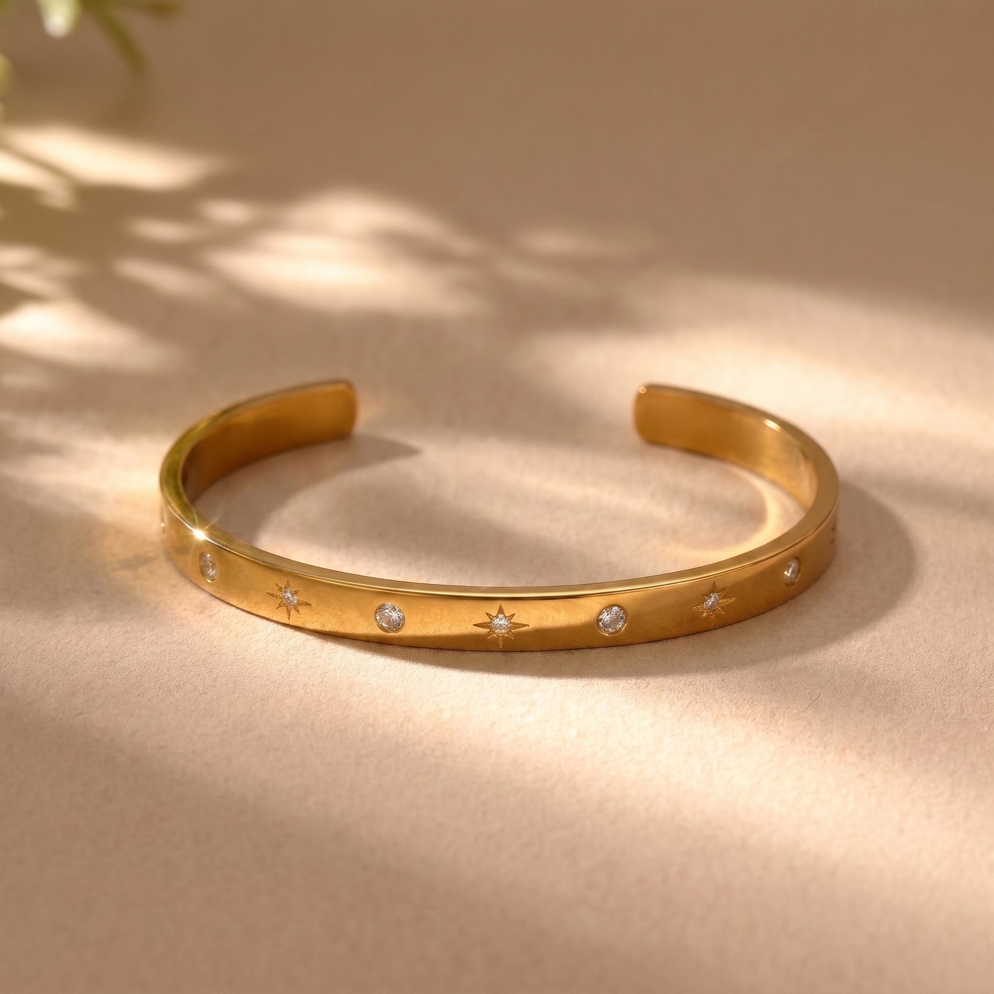Sleek gold Aria Bangle featuring channel-set clear baguette crystals on a clean background, highlighting its tarnish-free and skin friendly finish.