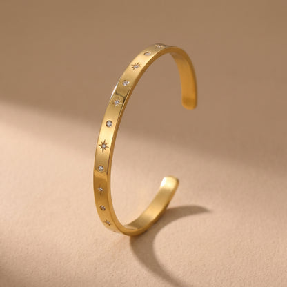 Sleek gold Aria Bangle featuring channel-set clear baguette crystals on a clean background, highlighting its tarnish-free and skin friendly finish.
