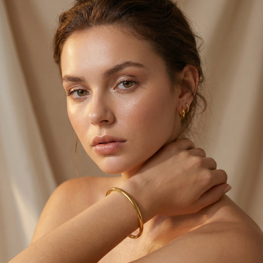 Woman wearing high quality Aura Minimalist Cuff Bangle by Floravisha against a beige background