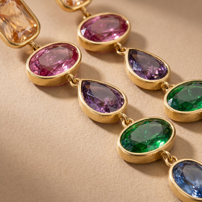 High quality waterproof gold plated cascading drop earrings featuring vibrant multi-color gemstones in champagne, ruby, amethyst, emerald, and sapphire, set against a pristine background.