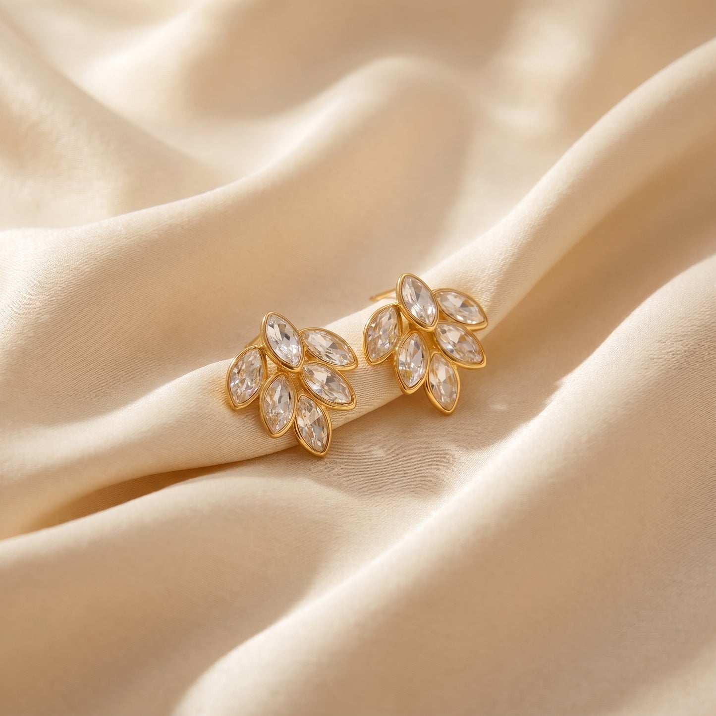High quality waterproof gold plated stud earrings featuring a modern fan design with clear marquise-cut crystals.