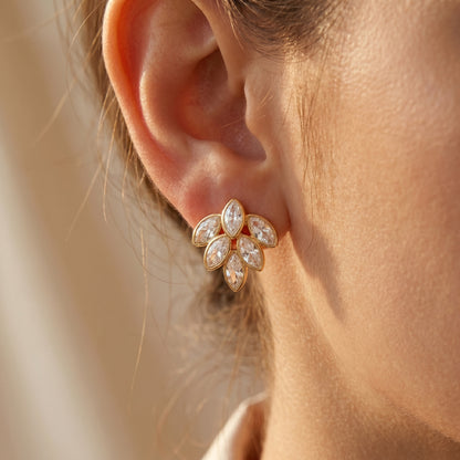 Close-up of a person wearing a High quality waterproof gold plated stud earrings featuring a modern fan design with clear marquise-cut crystals.