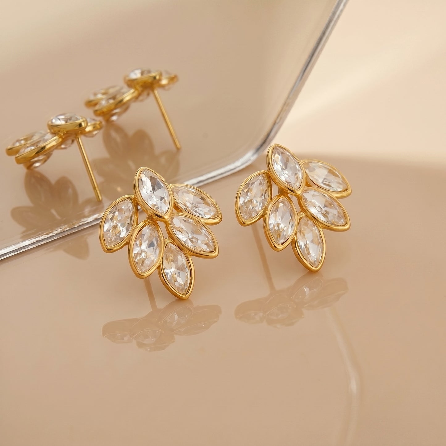 High quality waterproof gold plated stud earrings featuring a modern fan design with clear marquise-cut crystals.