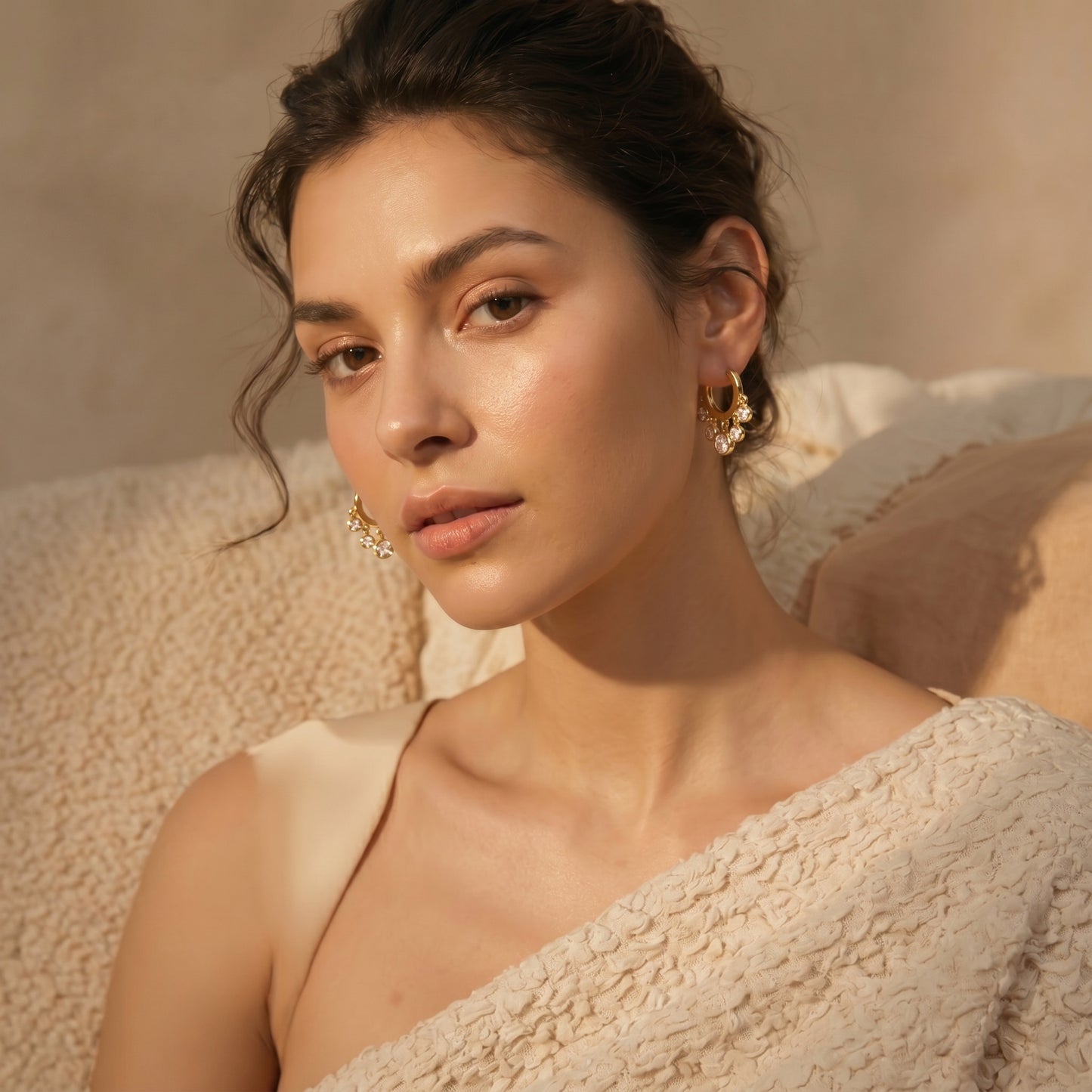 Model showcasing clear crystal gold-plated dangle earrings for a minimalist luxury look.