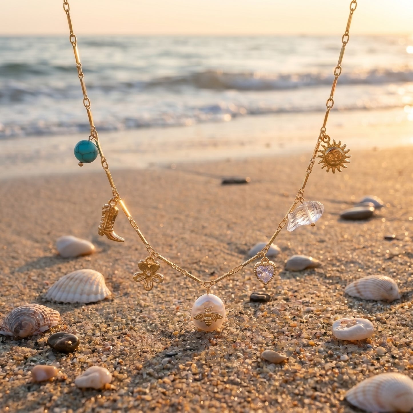 Necklace with various charms on a sandy beach