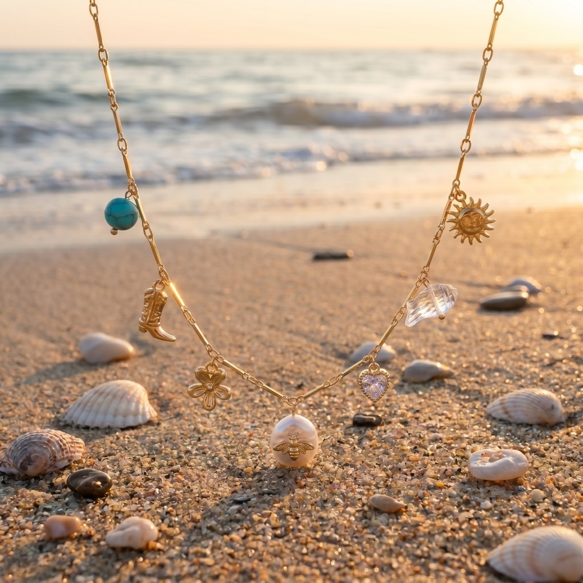 Necklace with various charms on a sandy beach