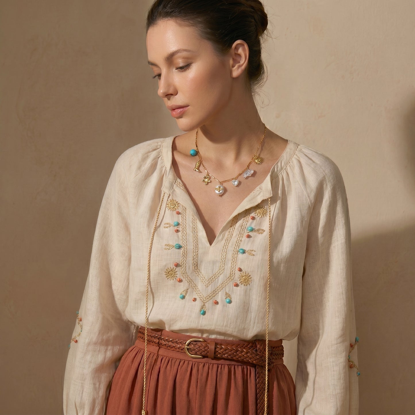 High quality waterproof gold plated charm necklace featuring eclectic pendants including a sun, cowboy boot, bee on a pearl, and a crystal heart.