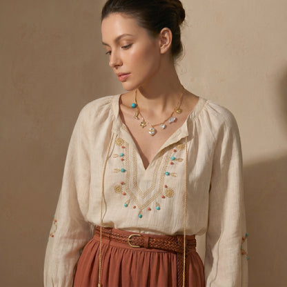 High quality waterproof gold plated charm necklace featuring eclectic pendants including a sun, cowboy boot, bee on a pearl, and a crystal heart.