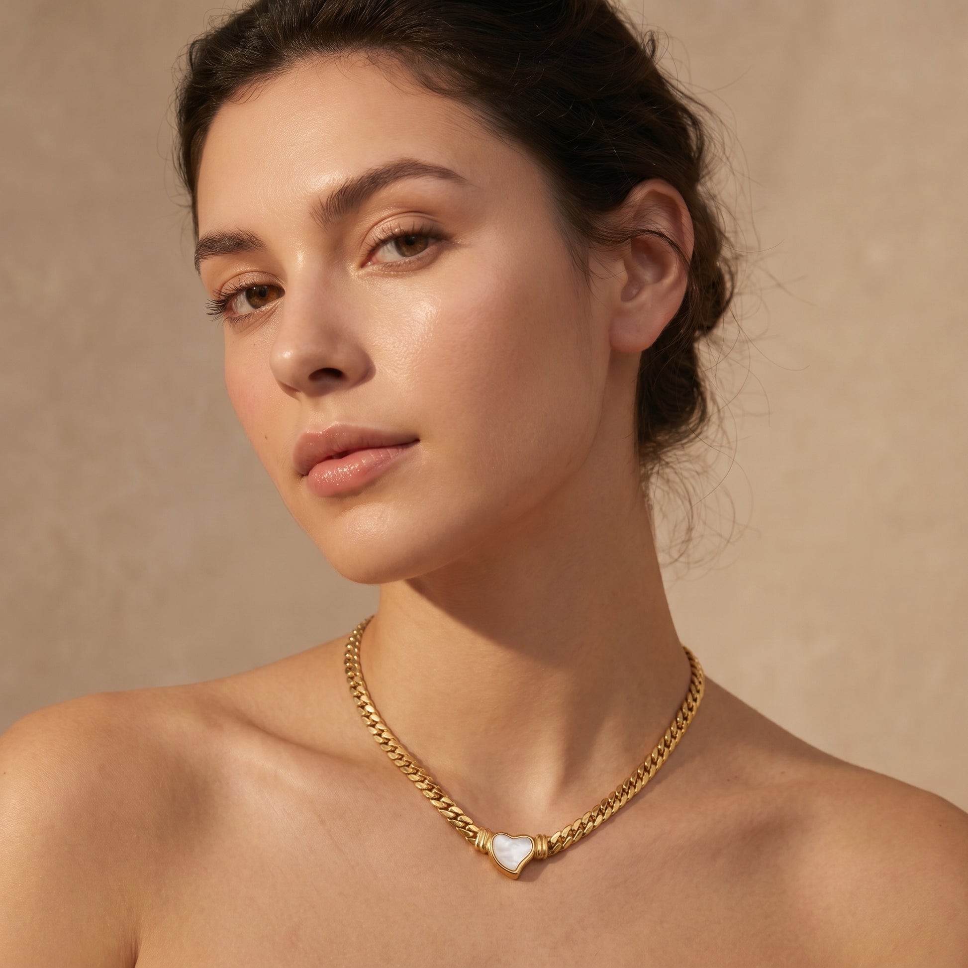 woman wearing gold heart pendant choker necklace minimalist elegant jewelry close-up