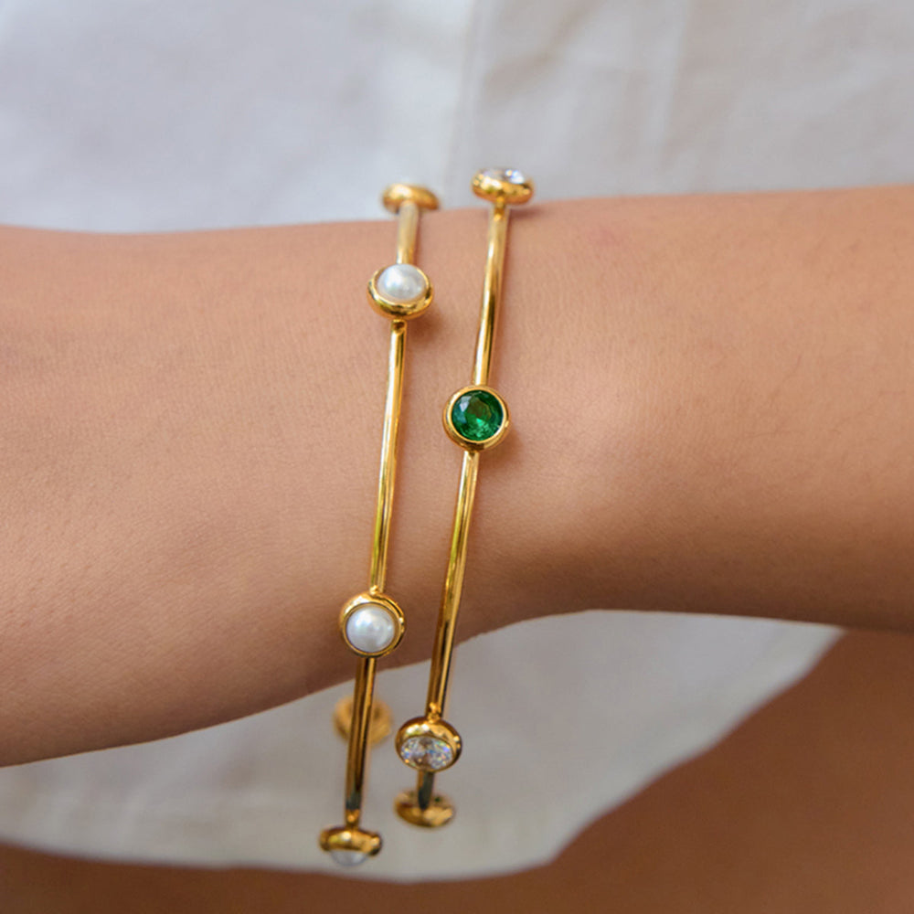 Gold bangles with gemstones