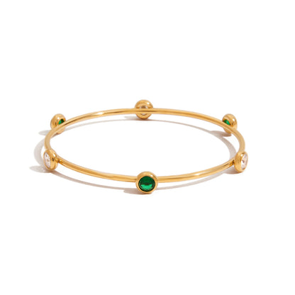 Gold bracelet with green gemstones 