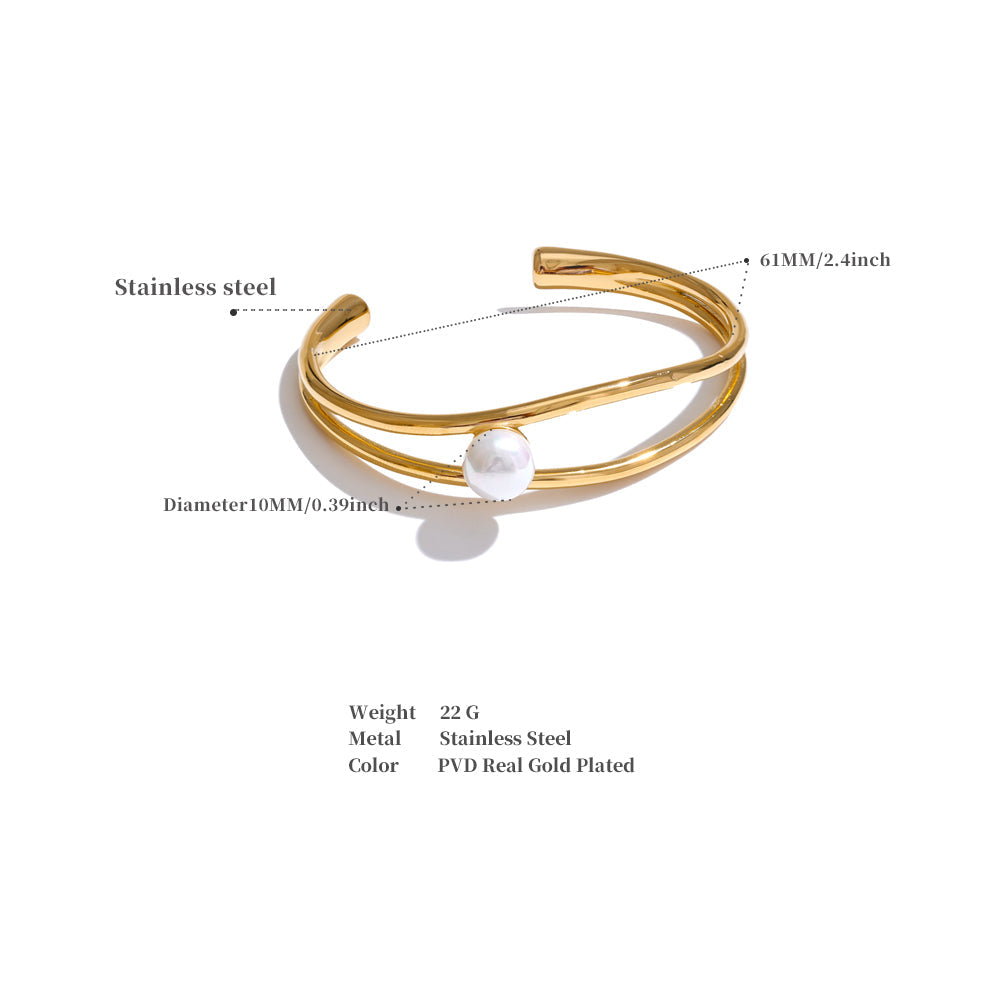 Gold bracelet with pearl detail on a white background
