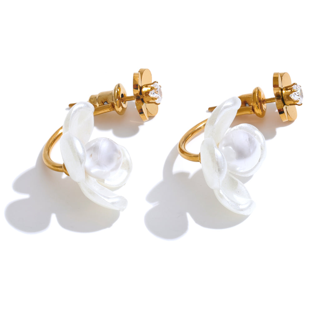 Gold hoop earrings with white floral designs on a white background.  latest earring models and trending earrings models. new arrivals.