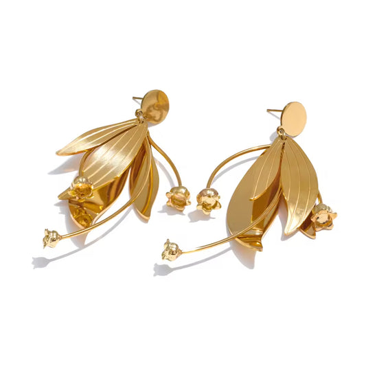 Gold leaf-shaped earrings on a white background.  latest earring models and trending earrings models. new arrivals.