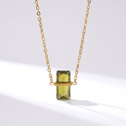 Gold necklace with a green rectangular gemstone on a white background