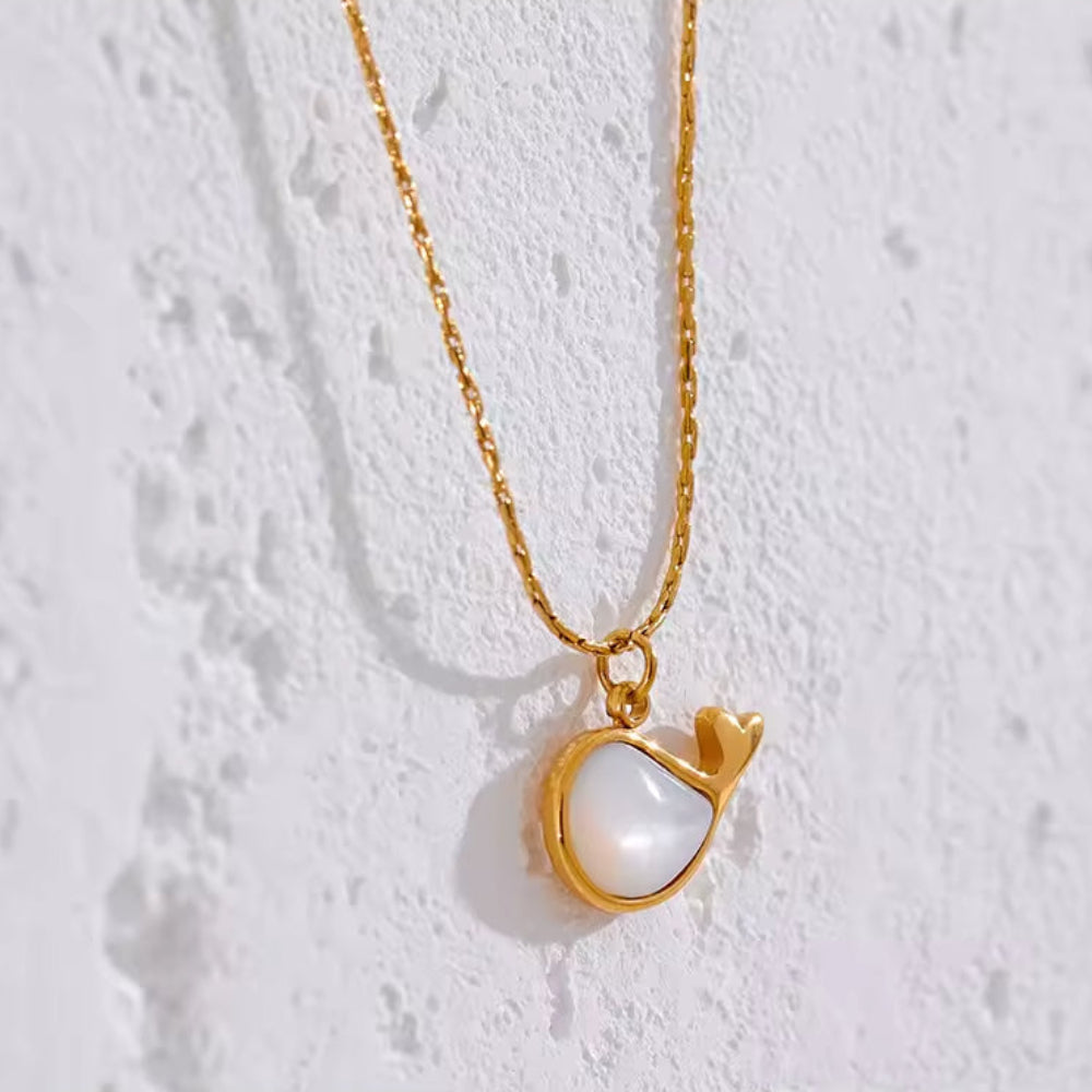 Gold necklace with a heart-shaped pendant.