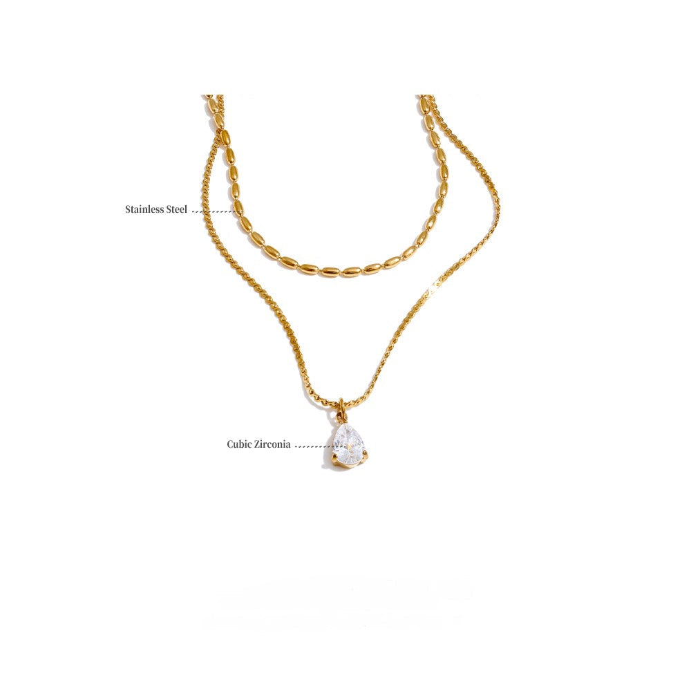 Gold layered necklace with a pendant.