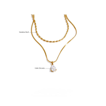 Gold layered necklace with a pendant.