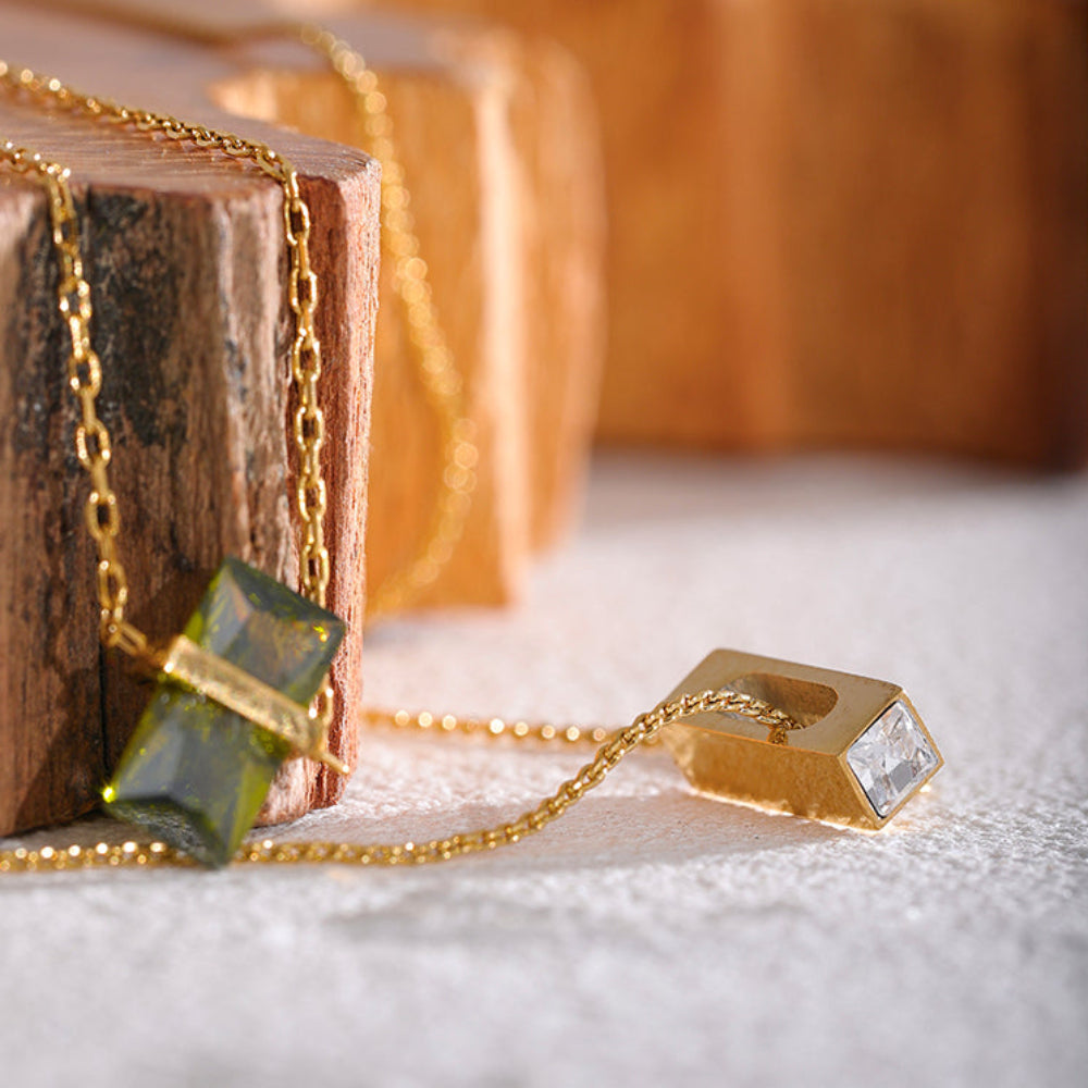 Gold necklace with geometric pendant.
