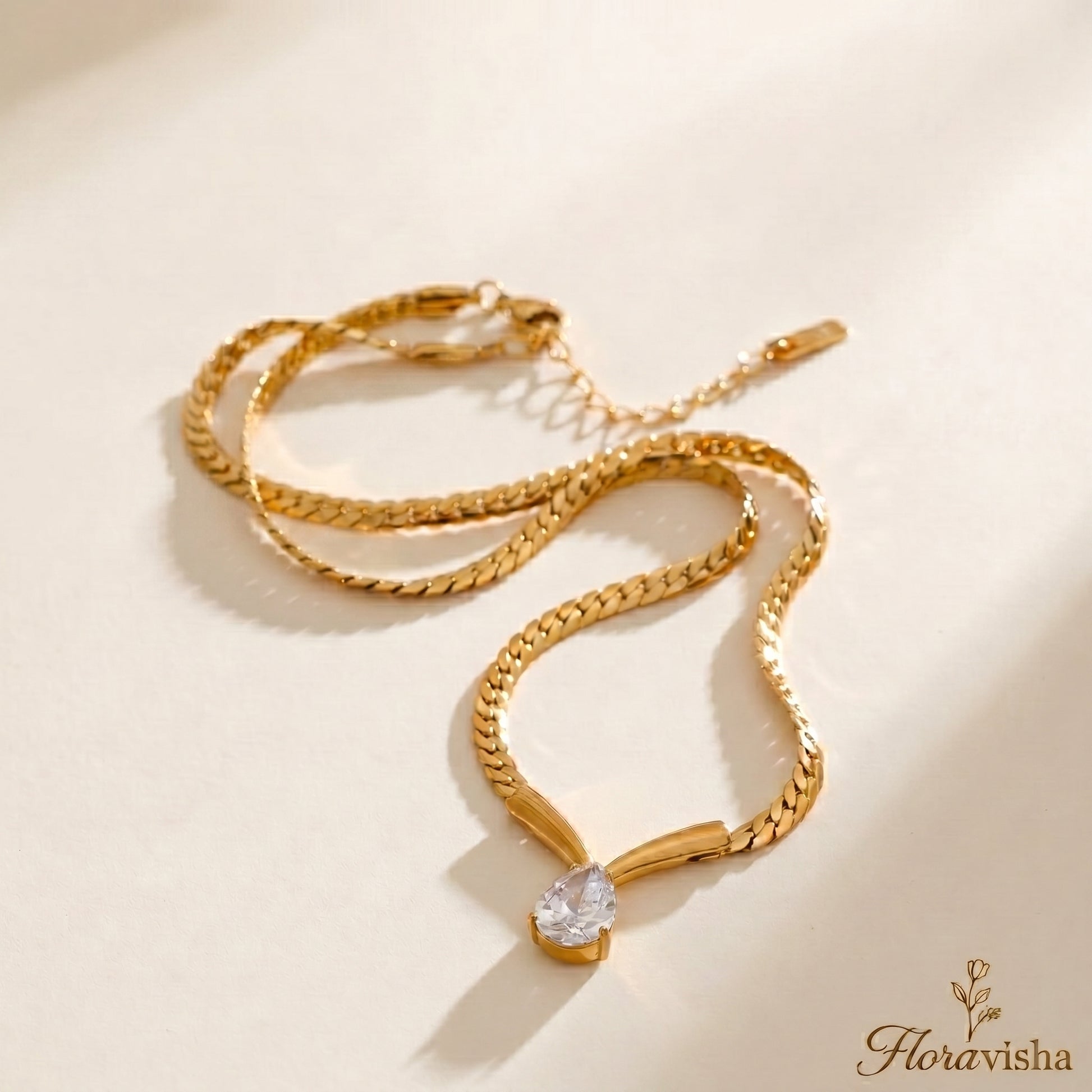 Gold snake chain necklace with teardrop crystal pendant, minimalist adjustable jewelry for women.