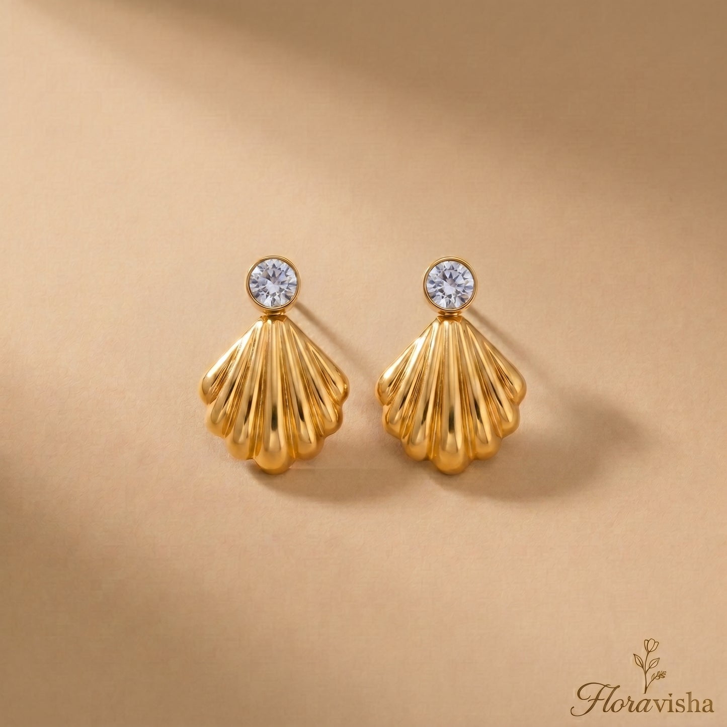 Waterproof gold-plated scallop shell drop earrings featuring a brilliant crystal stud by Floravisha. Displayed on a clean background highlighting the high-quality, skin-friendly jewelry design.