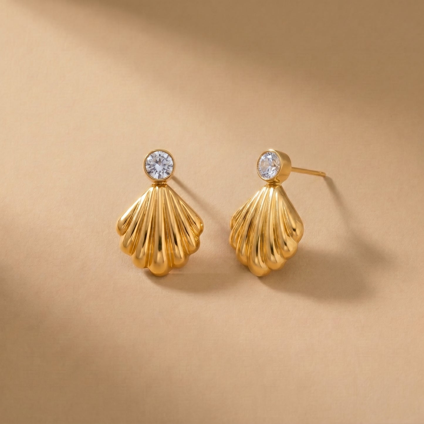 Waterproof gold-plated scallop shell drop earrings featuring a brilliant crystal stud by Floravisha. Displayed on a clean background highlighting the high-quality, skin-friendly jewelry design.