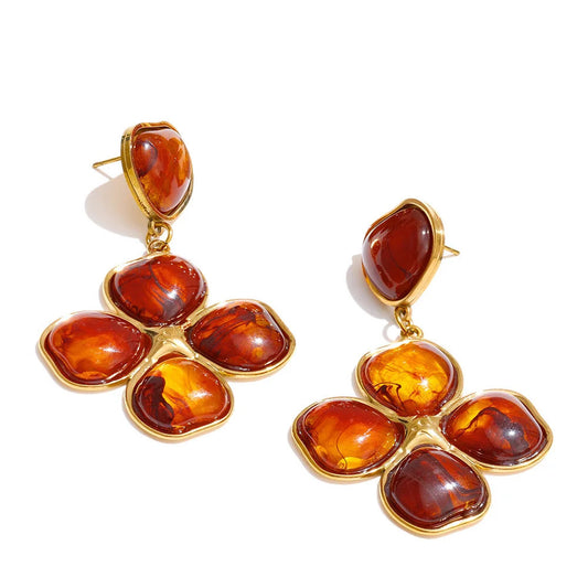 Pair of amber flower-shaped earrings with gold accents on a white background. latest models and trending models. new arrivals.