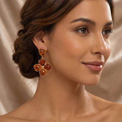 Woman wearing a pair of luxury amber floral drop earrings