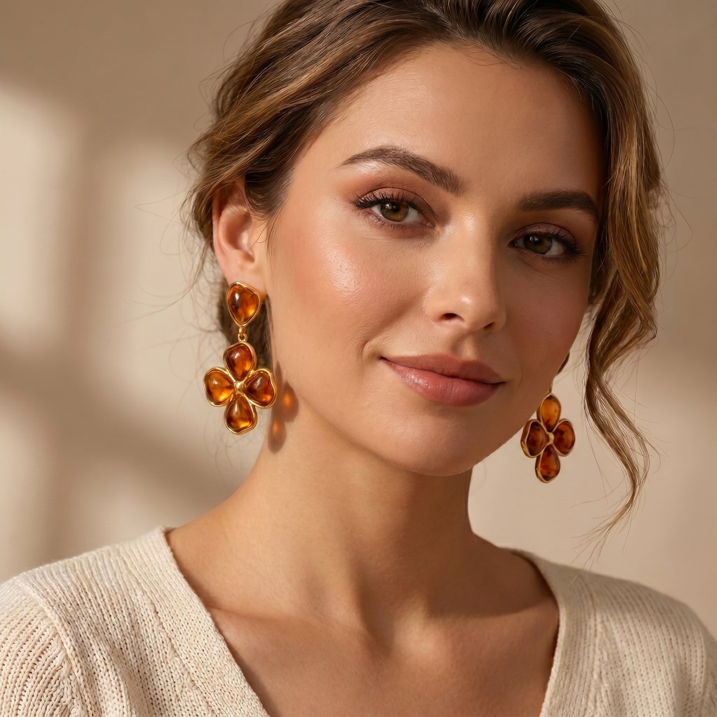 Woman wearing luxury amber floral drop earrings.
