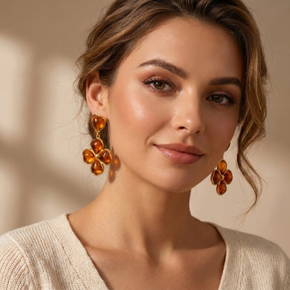 Woman wearing luxury amber floral drop earrings.