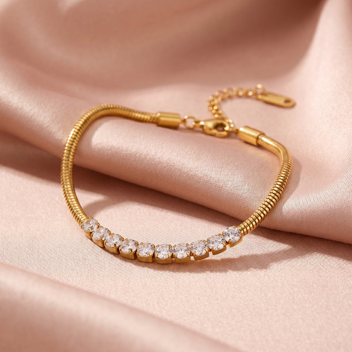 High quality waterproof gold plated snake chain bracelet featuring a row of clear crystals.