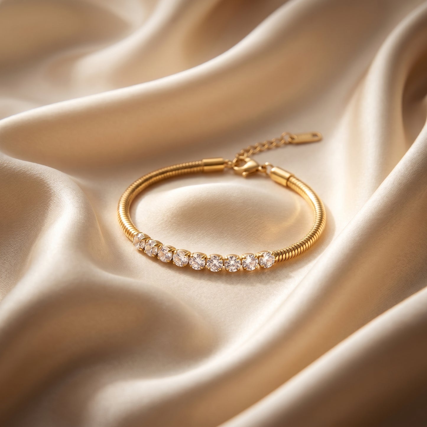 Gold bracelet with diamonds on a beige satin background