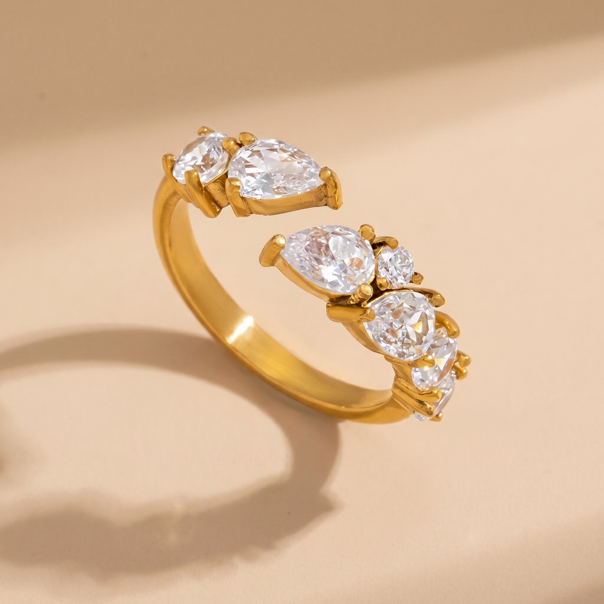 Aurora Crystal Cluster Adjustable Ring by Floravisha. A high-quality, waterproof gold-plated open wrap ring featuring an elegant, asymmetrical botanical cluster of teardrop and round clear crystals. Tarnish-free and skin-friendly.