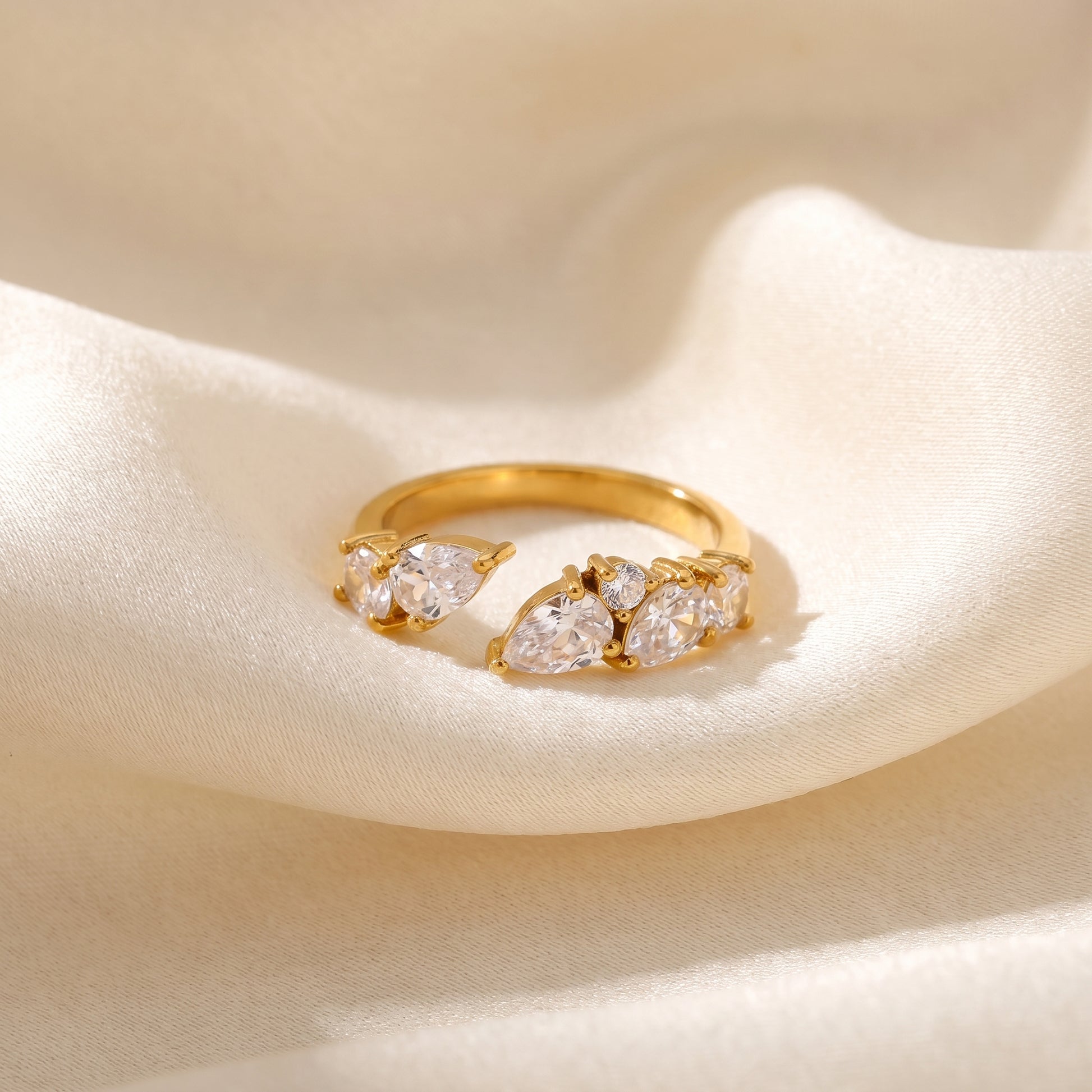 Aurora Crystal Cluster Adjustable Ring by Floravisha. A high-quality, waterproof gold-plated open wrap ring featuring an elegant, asymmetrical botanical cluster of teardrop and round clear crystals. Tarnish-free and skin-friendly.