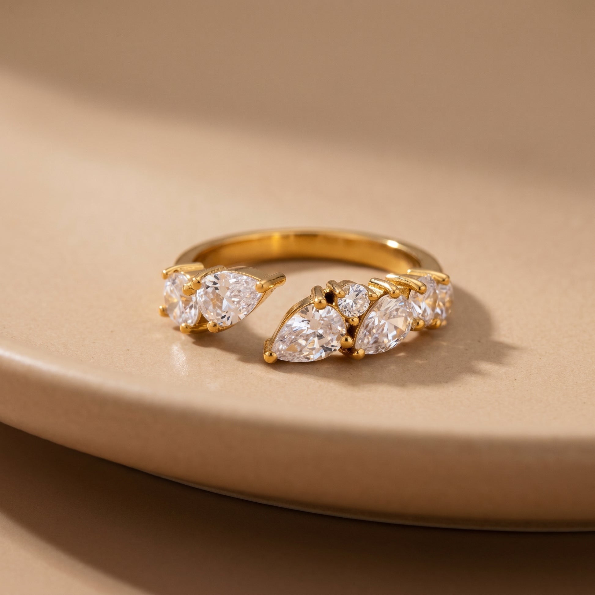 Aurora Crystal Cluster Adjustable Ring by Floravisha. A high-quality, waterproof gold-plated open wrap ring featuring an elegant, asymmetrical botanical cluster of teardrop and round clear crystals. Tarnish-free and skin-friendly.