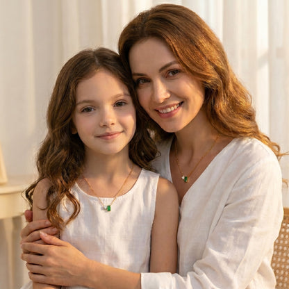Woman and young girl wearing Minimalist Chic Pendant Necklace and hugging outdoors with a warm, soft light.