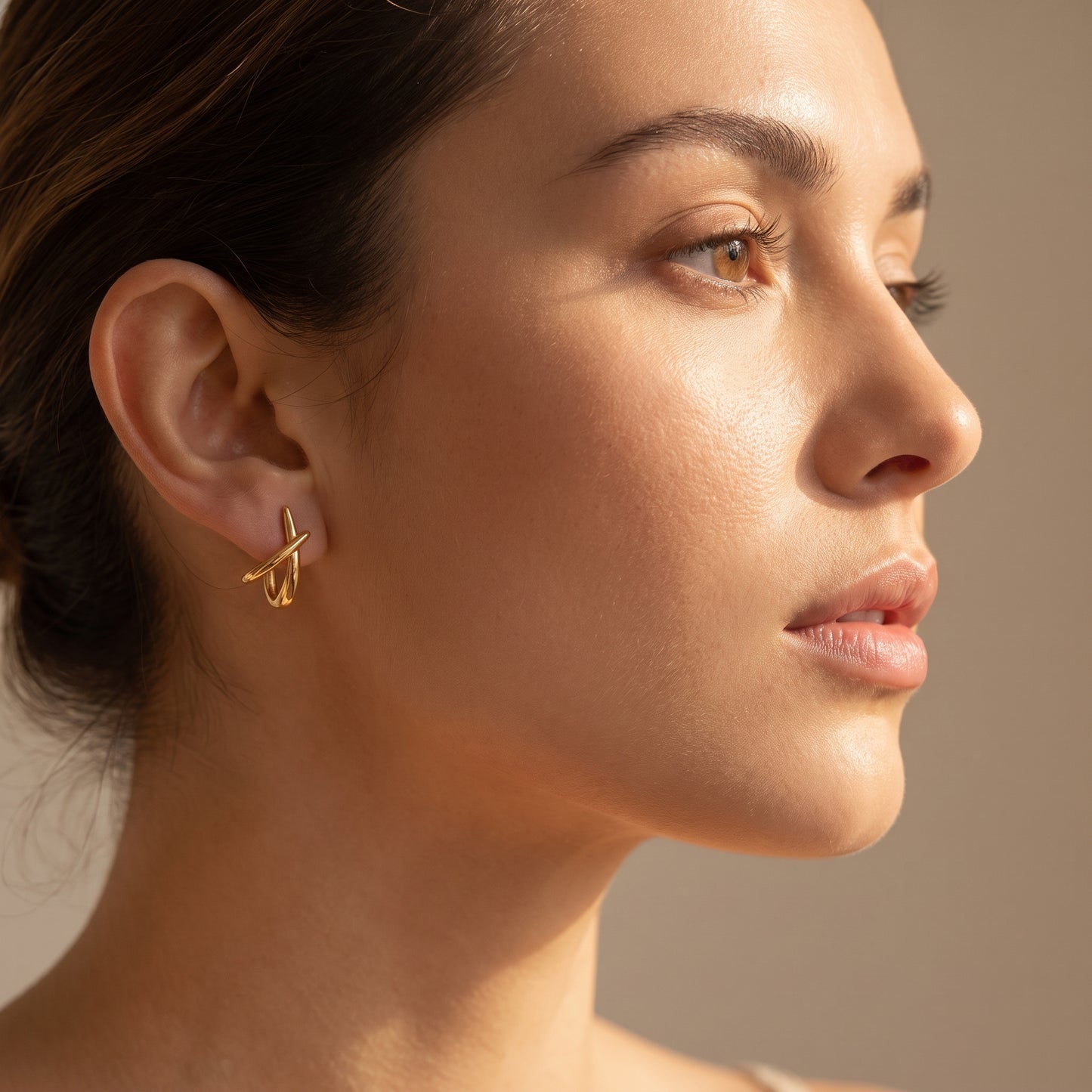 woman wearing a Floravisha Sienne Crossover Hoop Earrings in high quality 18k waterproof gold plating