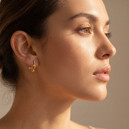 woman wearing a Floravisha Sienne Crossover Hoop Earrings in high quality 18k waterproof gold plating