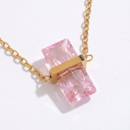 Necklace with pink crystal pendant and gold chain on a white background