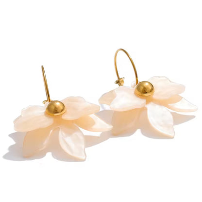 Pair of floral earrings with gold accents on a white background. latest earring models and trending earrings models. new arrivals.