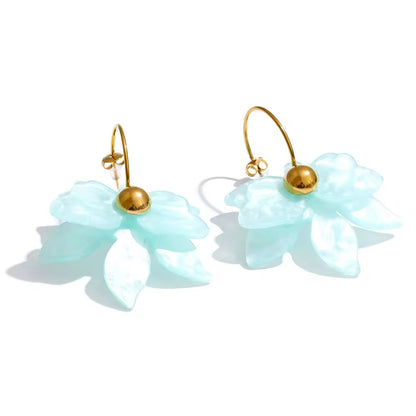 Pair of light blue flower-shaped earrings with gold accents on a white background. latest earring models and trending earrings models. new arrivals.