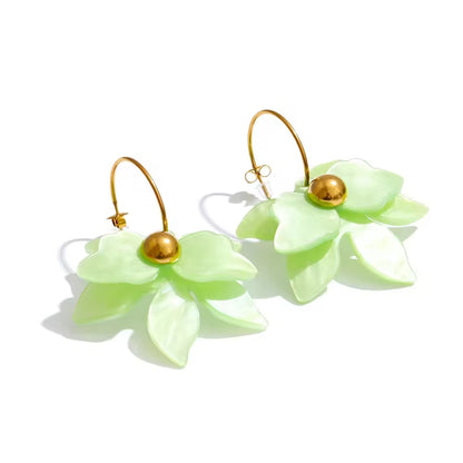 Pair of light green flower-shaped earrings with gold beads on a white background. latest earring models and trending earrings models. new arrivals.