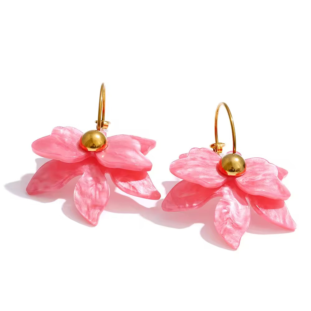 Pink flower-shaped earrings with gold centers on a white background. latest earring models and trending earrings models. new arrivals.