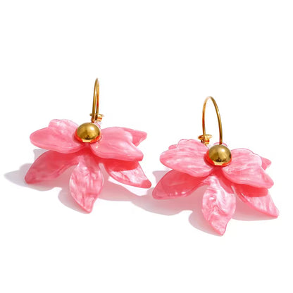 Pink flower-shaped earrings with gold centers on a white background. latest earring models and trending earrings models. new arrivals.