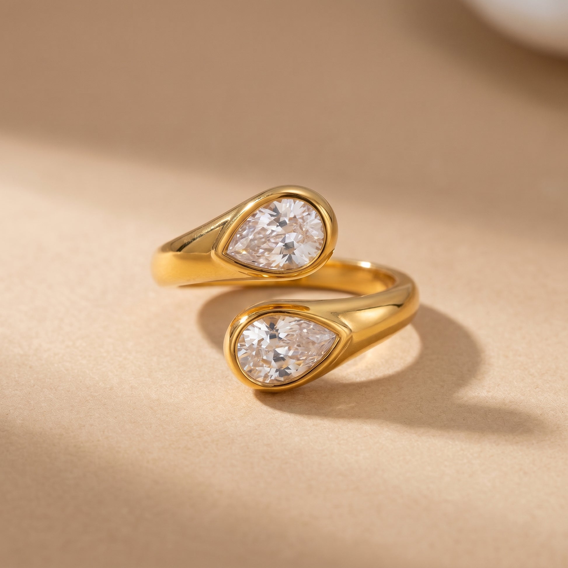Soleil Toi et Moi Adjustable Ring by Floravisha. A high quality, waterproof gold plated open wrap ring featuring two brilliant teardrop-cut clear crystals. Elegant, tarnish-free, and skin friendly.