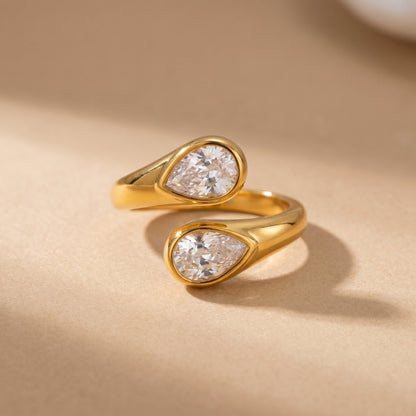 Soleil Toi et Moi Adjustable Ring by Floravisha. A high quality, waterproof gold plated open wrap ring featuring two brilliant teardrop-cut clear crystals. Elegant, tarnish-free, and skin friendly.