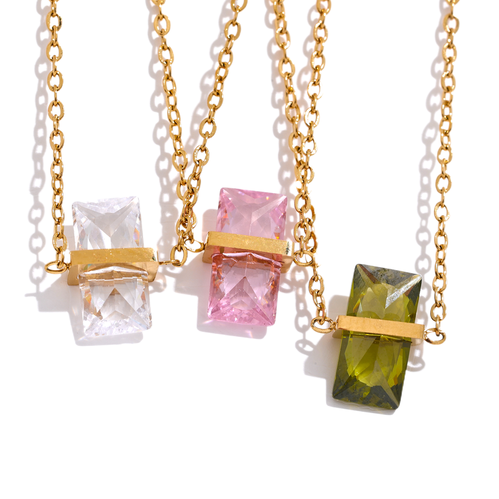 Three gold necklaces with colorful gemstone pendants.